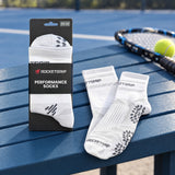 RocketGrip Performance Socks packaging on a tennis court